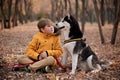 Walking the beautiful husky dog in the autumn park Royalty Free Stock Photo