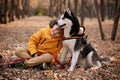 Walking the beautiful husky dog in the autumn park Royalty Free Stock Photo