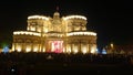 Indian bengali golden enlighted puja pandal crowded with pilgrims