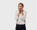 A very surprised business lady dressed in classic office clothes brought her hands to her face. Surprise from sales Royalty Free Stock Photo