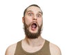 Very surprised scared funny face of a bearded guy with open mouth and big eyes on an isolated background