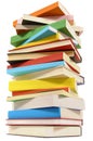 Very tall pile of books on white background, low angle view