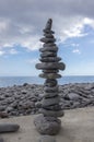 High stone cairn tower, poise stones, rock zen sculpture, light grey pebbles Royalty Free Stock Photo