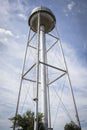 Very tall water tower under blue skies.