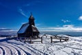 a very tall wooden church in the middle of snow covered ground Royalty Free Stock Photo