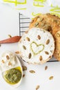 Very tasty and healthy carbohydrate breakfast. Freshly baked bagel with cream cheese, sunflower seeds and a painted heart topped Royalty Free Stock Photo
