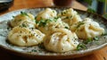 Very tasty manti left on a plate, sprinkled with herbs Royalty Free Stock Photo