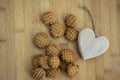 Very tasty peanut butter biscuits on bamboo wooden board with decorative wood heart, golden baked healthy Royalty Free Stock Photo