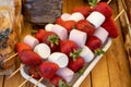 very tasty strawberry dessert with marshmallows on a spit Royalty Free Stock Photo