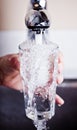 Very thirsty man filling an overflowing glass of water Royalty Free Stock Photo