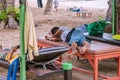 Very tired asian tourist sleep care free on bathing bed at Sanur beach, Bali. Sanur, Indonesia - January 5, 2020