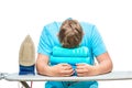 A very tired man fell asleep while ironing towels