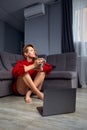 Very tired young woman, burning the midnigh oil - working late at night on her laptop computer, at home, sitting on sofa Royalty Free Stock Photo