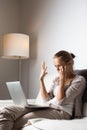 Very tired young woman working late at night on her laptop computer Royalty Free Stock Photo