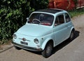 Very well preserved vintage Fiat 500 car parked on the road side.