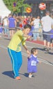 Very young asian girl and her mother running