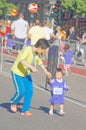 Very young asian girl and her mother running