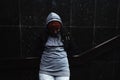 Very young hungry and scared homeless teenager girl standing alone on the street in the cold winter day feeling abandoned and anxi