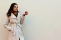 Woman in a coat holding a bitten red juicy apple Royalty Free Stock Photo