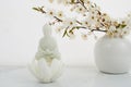 Vesak, Wesak, Buddha birthday. Buddha statue with blossoming cherry on white background. Spa ritual. Mental health and