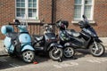 Vespa moped and scooters along with a motorbike Royalty Free Stock Photo