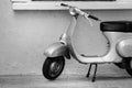 Vespa motorcycle parked next to the wall Royalty Free Stock Photo