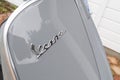 Vespa text sign and brand logo on front of grey gts vintage scooter gray