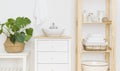 Vessel sink near bathroom shelves with spa cosmetics and accessories