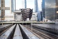 Vessel  TKA, a spiral staircase, with railroad and trains in front, skycrappers behind,  Hudson Yards, Manhattan`s West Side, NY Royalty Free Stock Photo