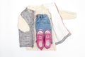 Vest,warm jumper,sweater,jeans pants,pink sneakers.Set of baby children's clothes,clothing for spring,autumn,winter on white Royalty Free Stock Photo