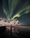 Vestrahorn mountain with aurora in south-east Iceland, covered by snow near the beach and sea in the winter