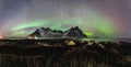 Vestrahorn Stockknes mountain range with aurora borealis and reflection at the beach in Iceland. One of the most Royalty Free Stock Photo