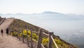 Vesuvius Mountain volcano path with a wooden fence and a panorama of Naples in the background