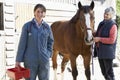 Vet In Discussion With Horse Owner