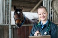 Female Vet Examining Horse In Stable Royalty Free Stock Photo