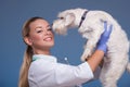 Vet holding a cute dog above head Royalty Free Stock Photo