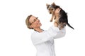 Vet holding up yorkshire terrier puppy and smiling Royalty Free Stock Photo