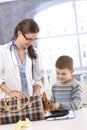 Vet and kid taking rabbit out of carrier Royalty Free Stock Photo