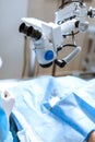 Vet ophthalmologist surgical microscope in operating room. and dog with injured eye on operating table, ready for operation Royalty Free Stock Photo