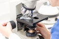 Vet puts a sample under the microscope and examines for pathogenic germs Royalty Free Stock Photo