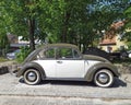 Veteran classic old car Volkswagen Beetle two colors parked