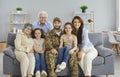 Portrait of happy military veteran together with his family sitting on sofa at home Royalty Free Stock Photo