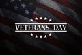 Veterans Day inscription on black textured background with USA flag. American holiday poster. Royalty Free Stock Photo