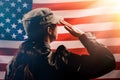 Veterans Day, Memorial Day, Independence Day.Silhouette of a female soldier saluting against the background of the American flag.