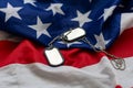 Veterans Day USA flag with dog tags on rustic red wood background, closeup. Royalty Free Stock Photo