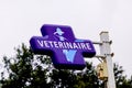 Veterinaire French veterinary clinic sign cross blue logo on a pole outdoor