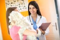 Veterinarian advising a girl about her Maltese dog in vet clinic Royalty Free Stock Photo