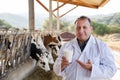 veterinarian approvingly demonstrating milk on dairy farm Royalty Free Stock Photo