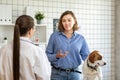 The veterinarian and the client with the dog to discuss the treatment in a veterinary clinic. Royalty Free Stock Photo