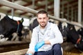 Veterinarian and cows in cowshed on dairy farm Royalty Free Stock Photo